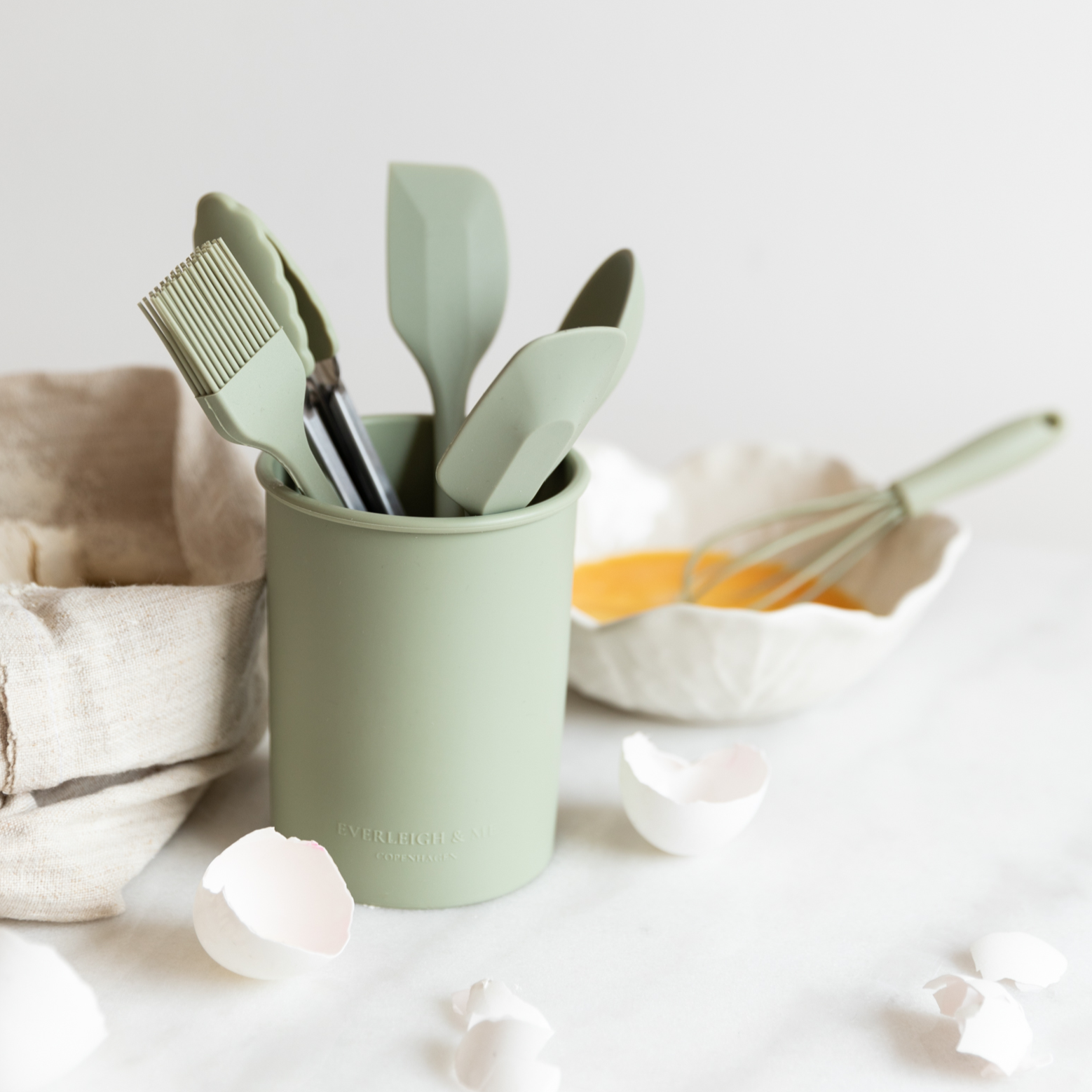 Child cooking with the Olive kitchen set from Everleigh & Me. The silicone kids utensils in a olive green color make cooking fun and educational in a stylish kitchen